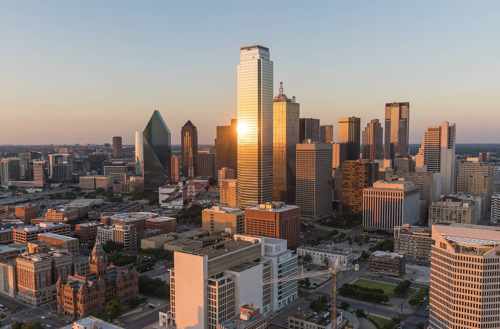 dallas-skyline-about-v2 Aerial shot of Downtown Dallas during sunset